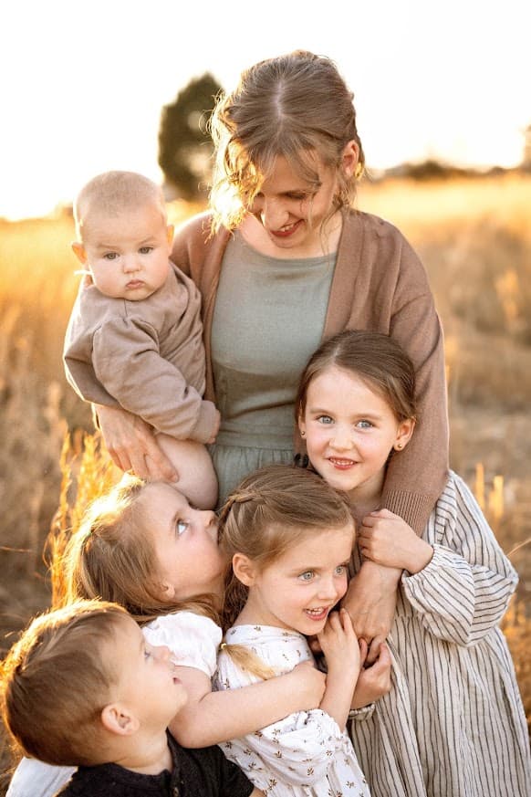 Madalyn with her children in a golden field